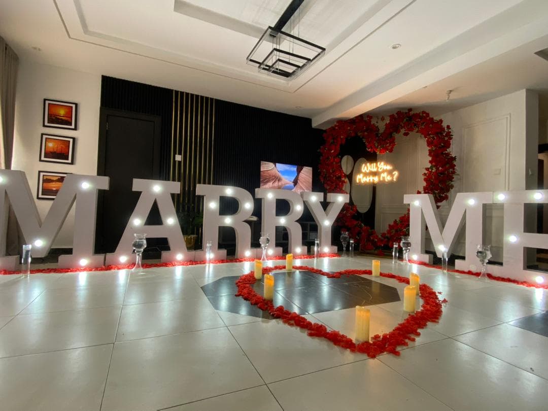 Luxury proposal setup by IGOS Events with candles and elegant floral décor.